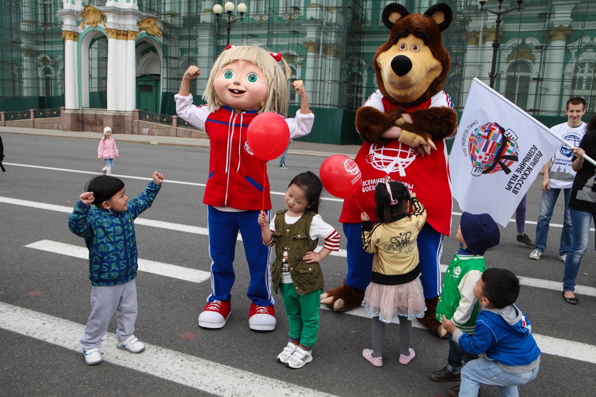 The mummers animated hero Russian TV series Masha and the Bear in the city center entertains city residents and tourists. It is photographed with those who wish