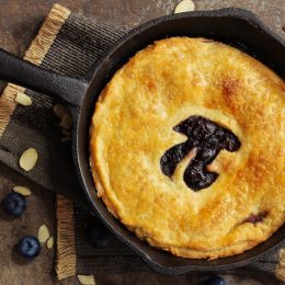 Pi Day special homemade blueberry pie baked in a skillet overhead view