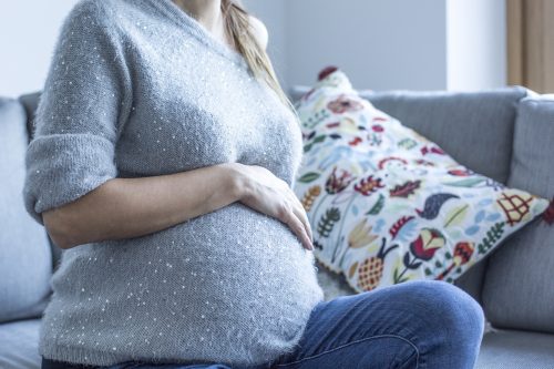 Pregnant woman sitting on a couch