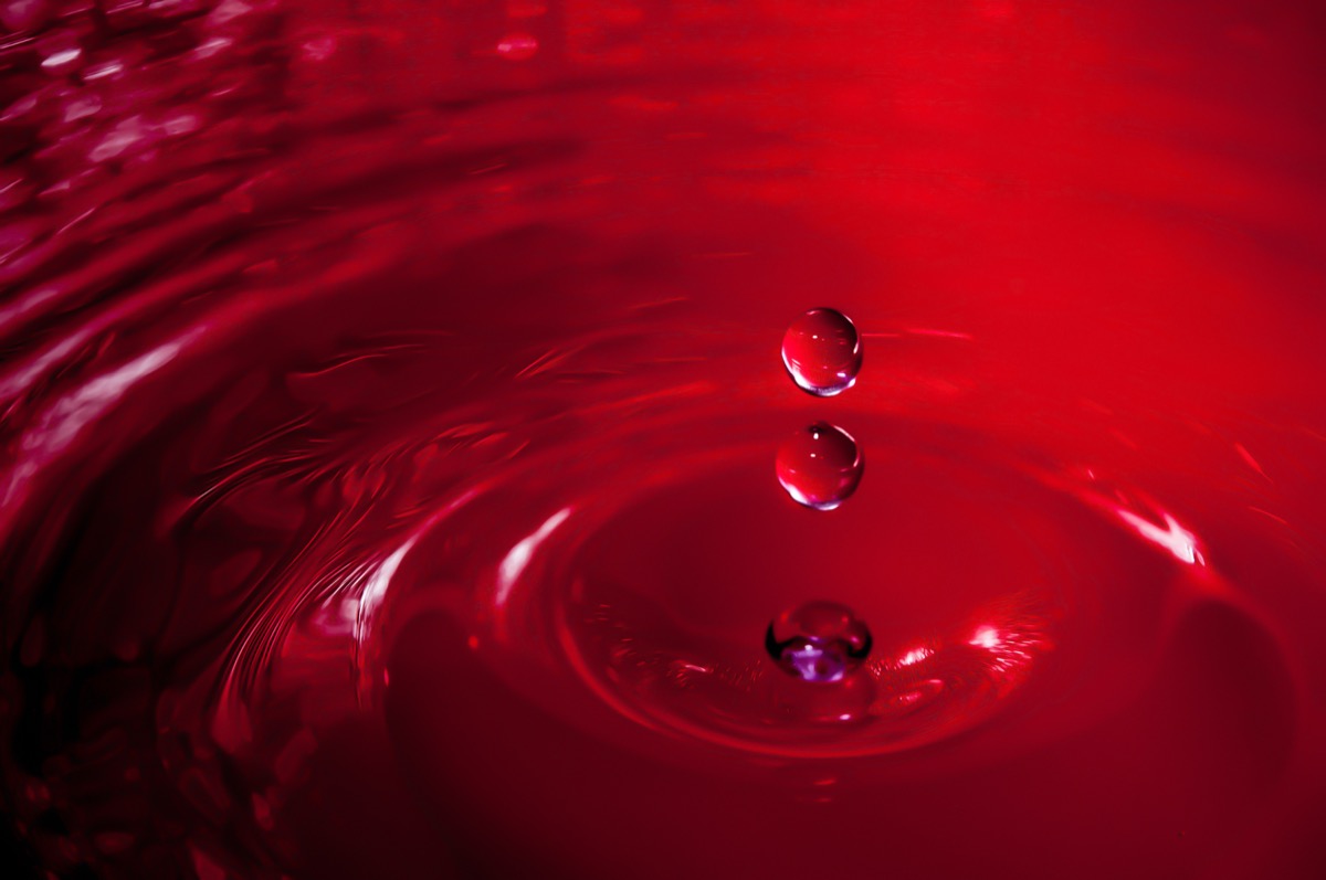 Photo of a drop of water on a red background