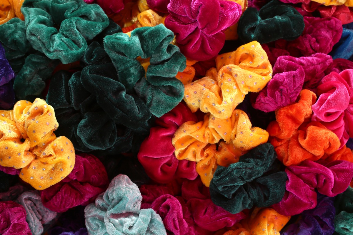 a pile of green, yellow, pink, orange, and multicolored scrunchies