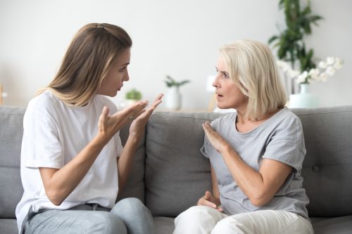 Woman arguing with mother on couch