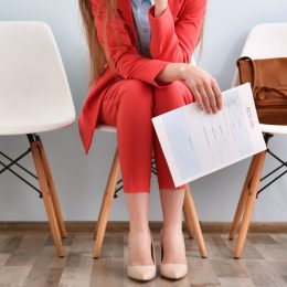 Young woman waiting for interview indoors