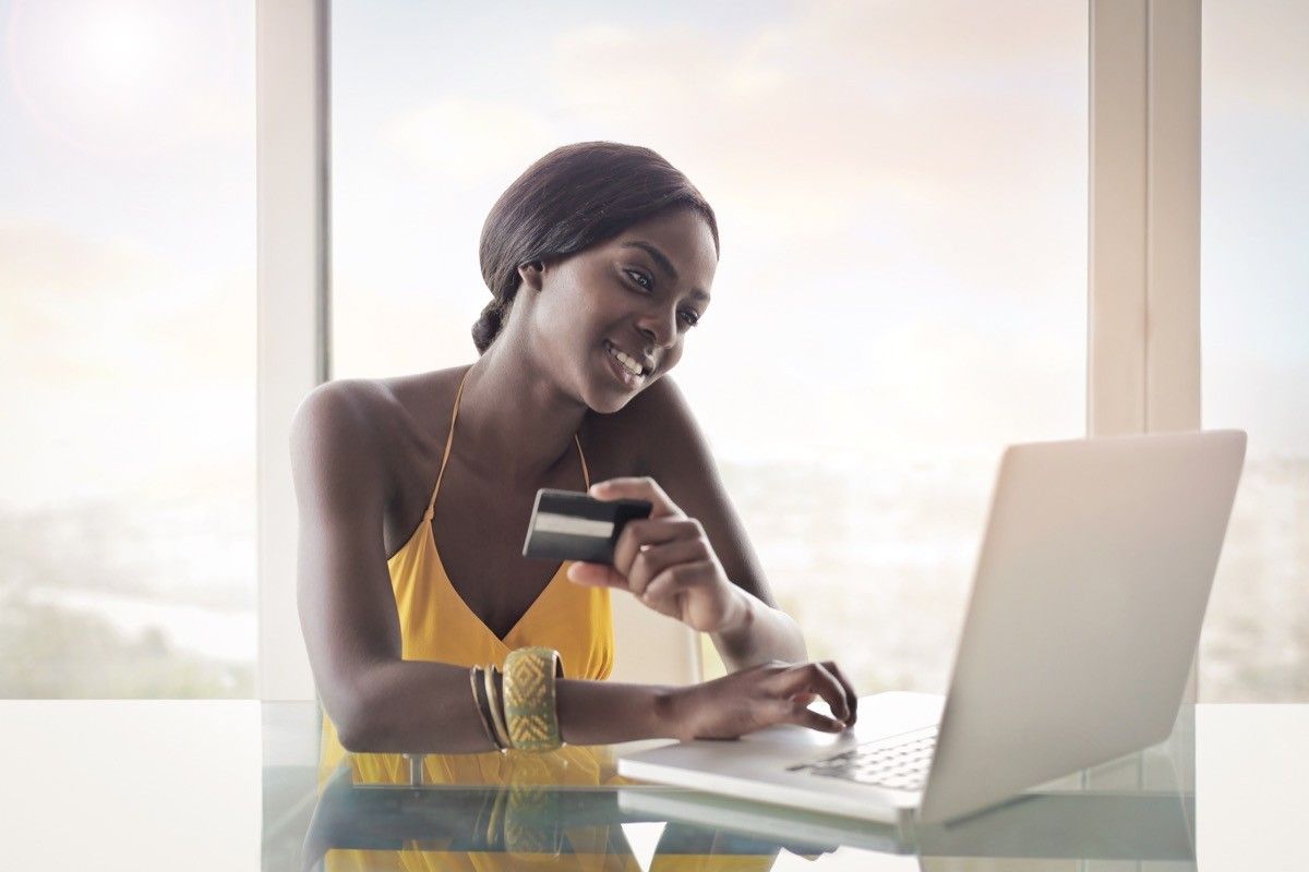 woman making online payment with credit card, skills parents should teach kids