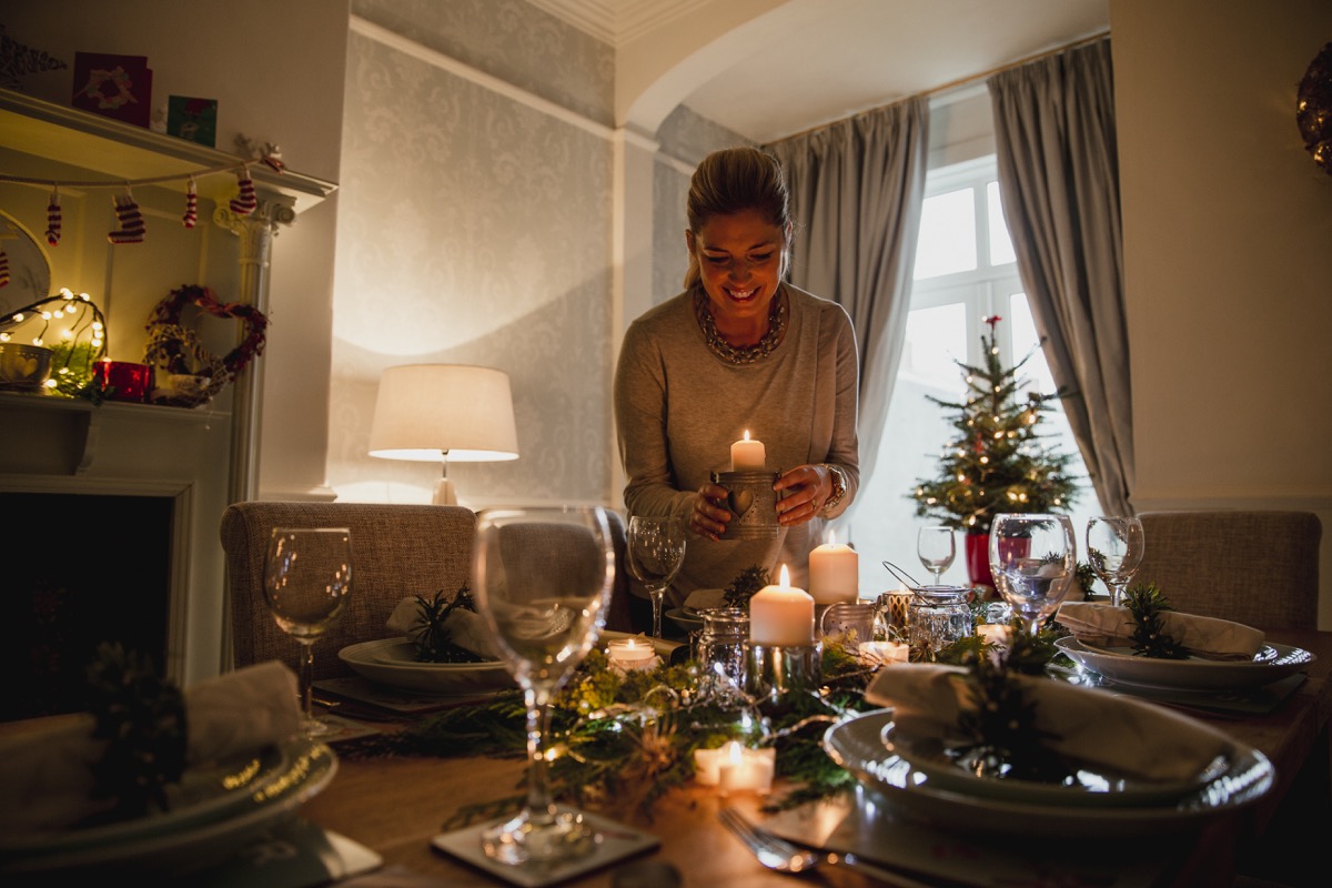 Woman setting the table with festive decorations