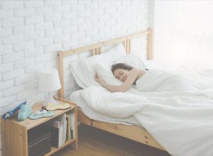 woman sleeping in a bed, subtle symptoms of serious disease