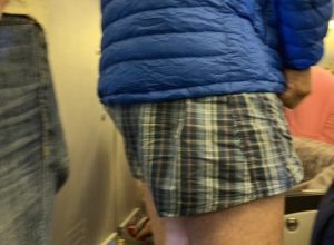 man takes off pants on long flight
