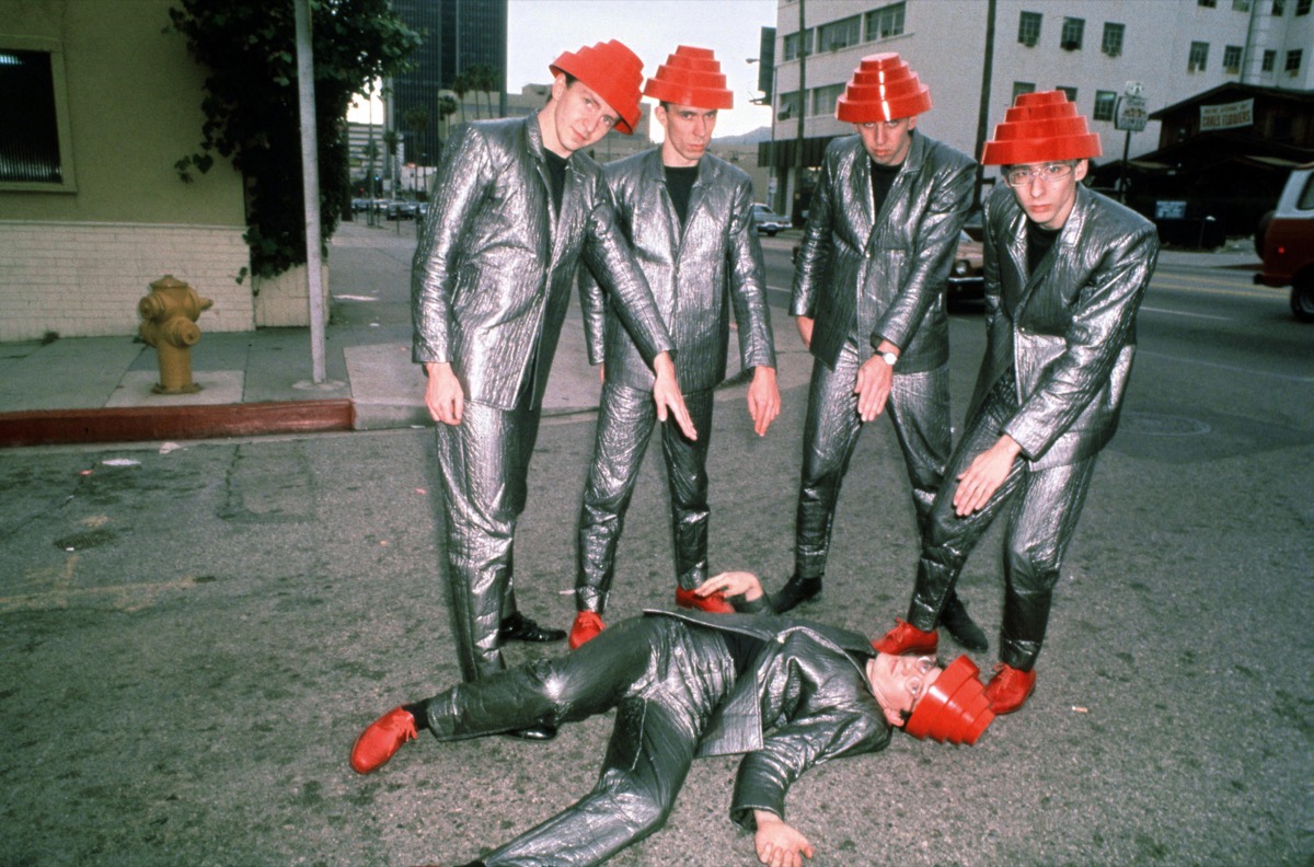 devo wearing silver suits and their signature red hats