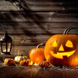 Halloween pumpkin head jack lantern on wooden background - halloween jokes, halloween puns