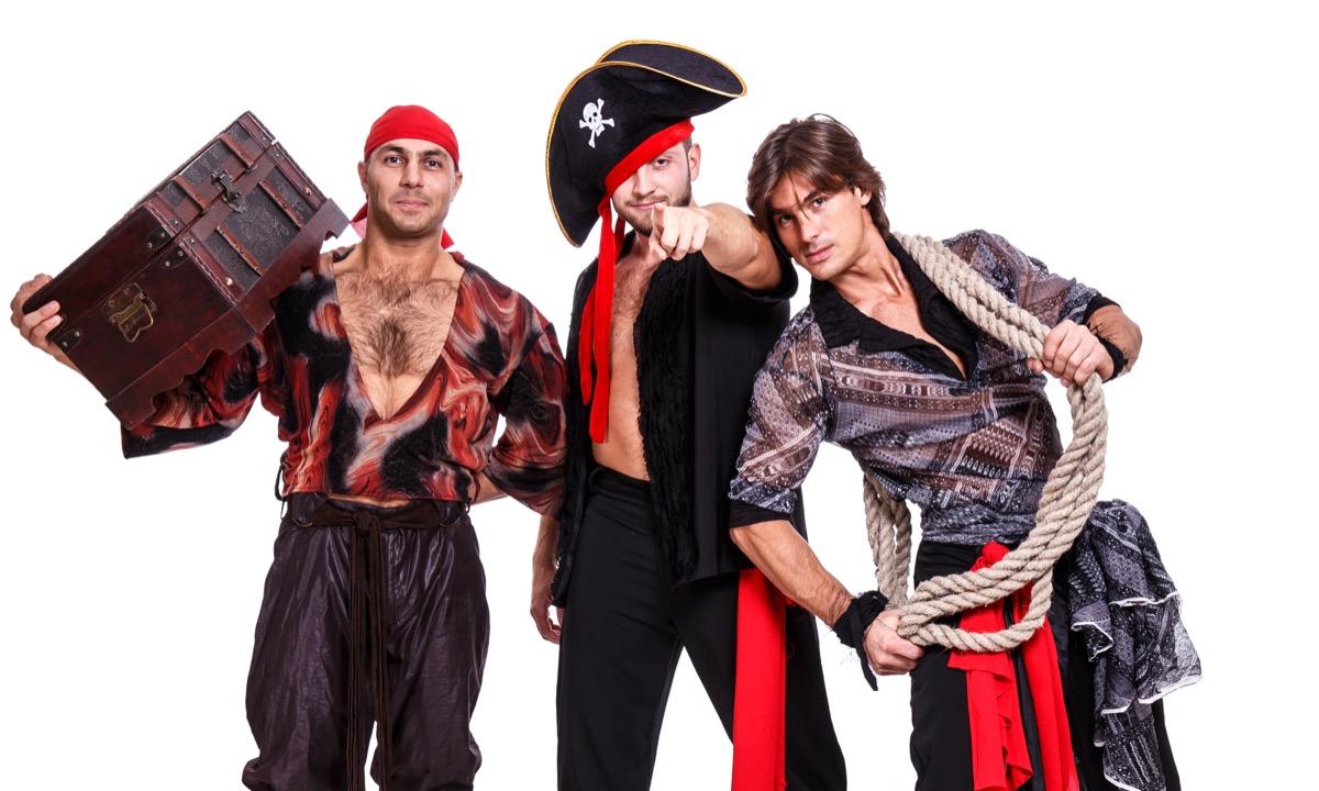 Three men dressed up as pirates with hats, scarves, and rope