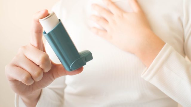woman holding asthma inhaler, school nurse secrets