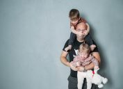 father with kids climbing all over him, bad parenting advice