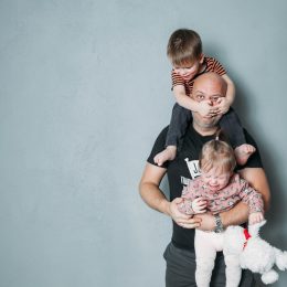 father with kids climbing all over him, bad parenting advice