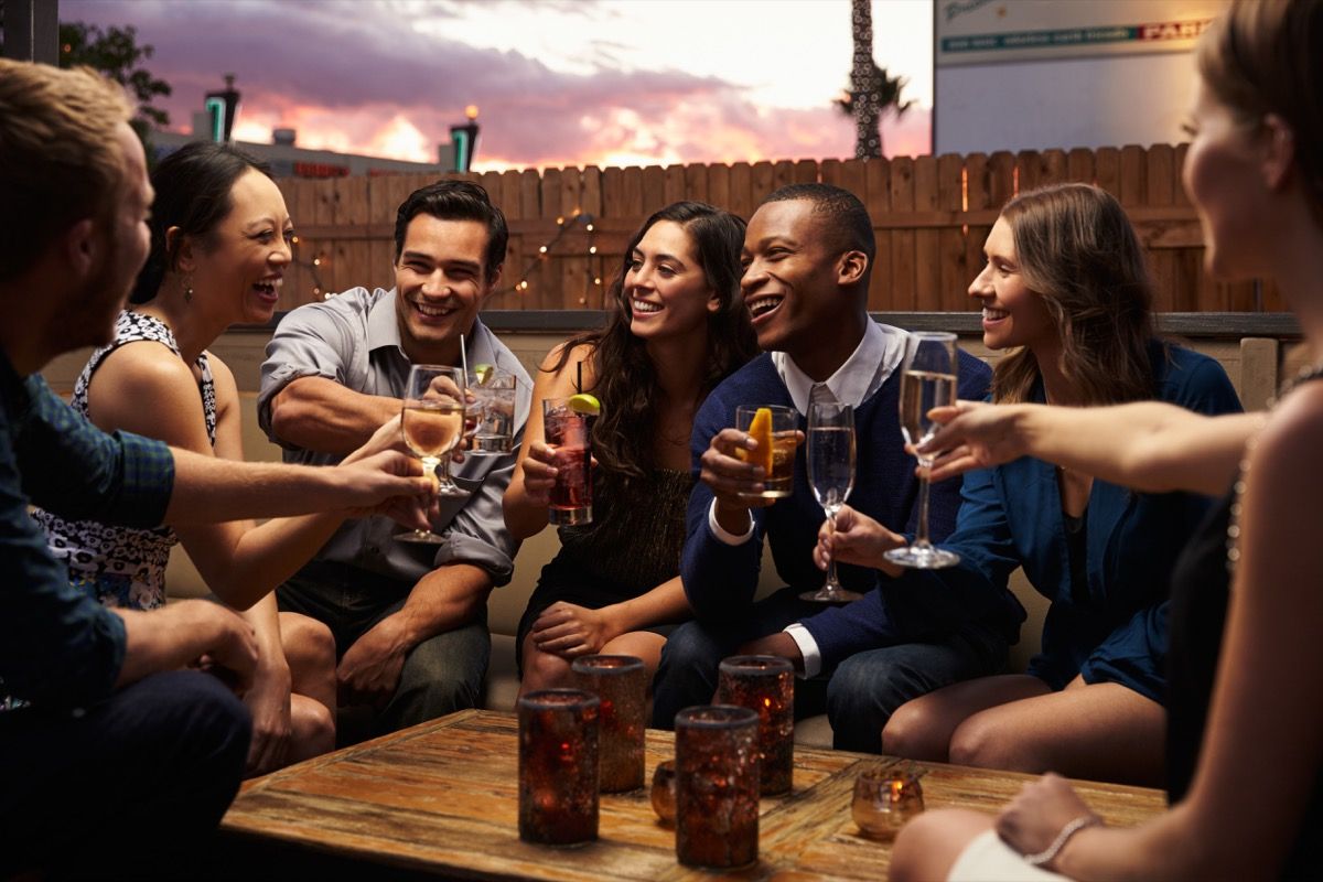 friends chatting at a cocktail party on a rooftop