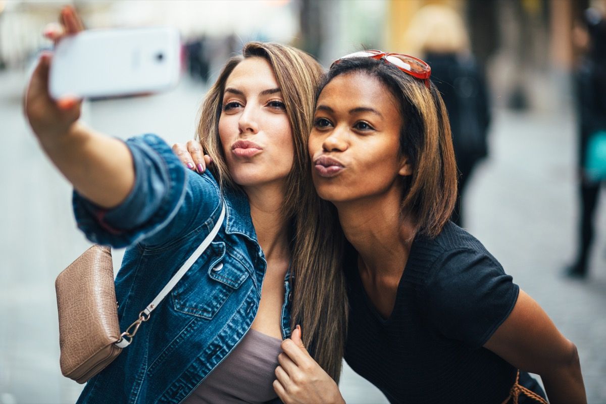 friends making a duck face while taking a selfie