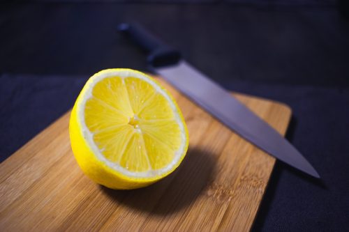 lemon on cutting board with knife