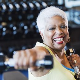 Older woman lifting weights at the gym