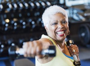 Older woman lifting weights at the gym