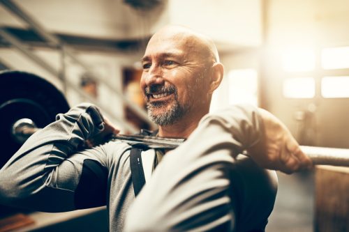 Older Man Lifting Weights at the Gym, look better after 40
