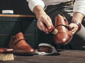 man shining light brown double monk strap shoes