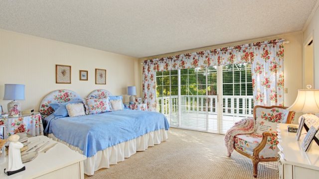 old fashioned home with floral bedding and curtains