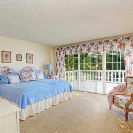 old fashioned home with floral bedding and curtains