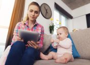 woman reads tablet, stay at home mom