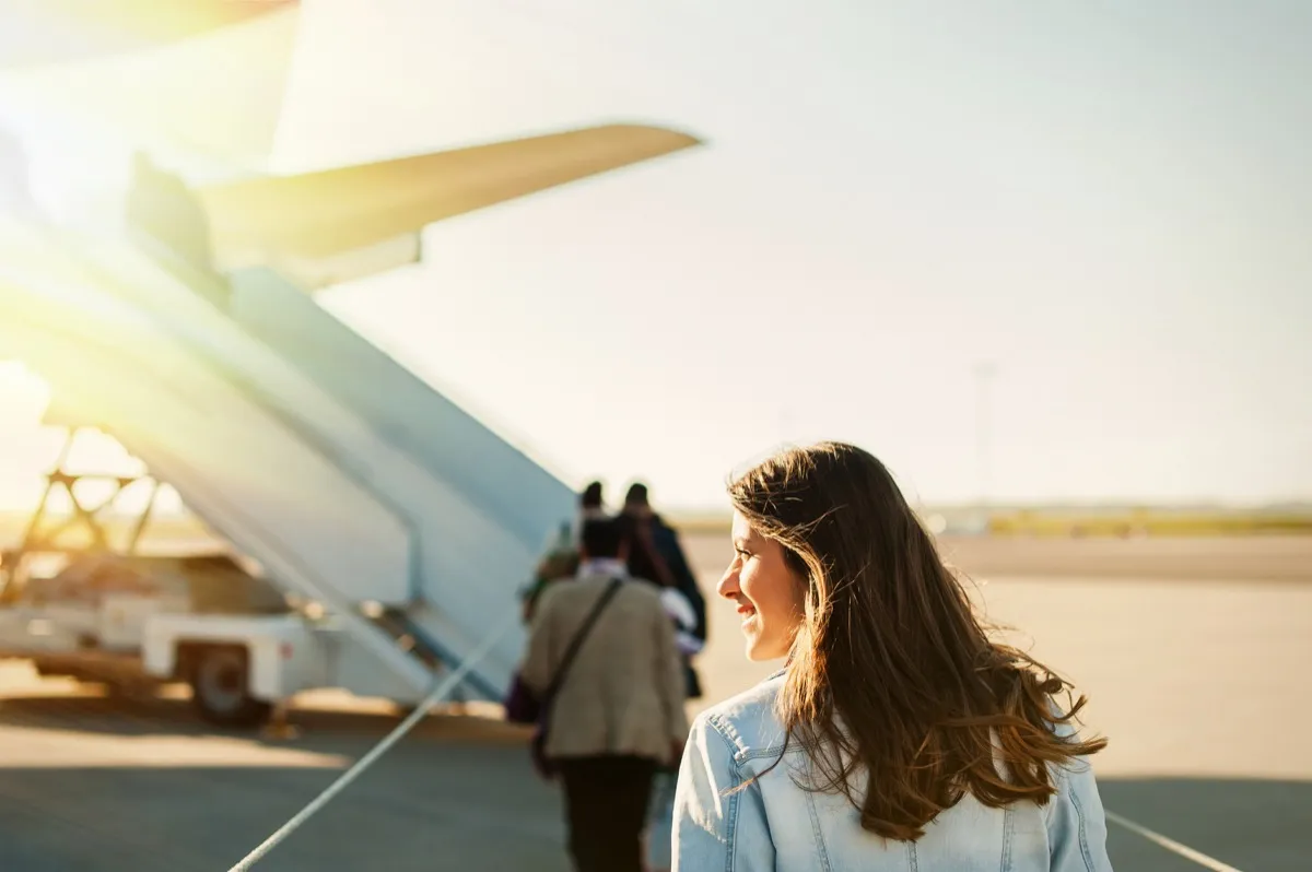 Woman boarding airplane booking cheap flights
