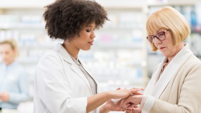 Senior Woman Talking To A Female Pharmacist