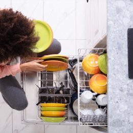 woman loading dishwasher,
