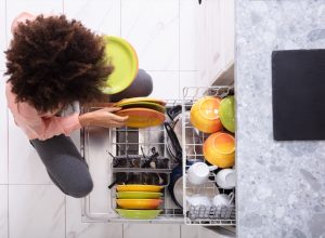 woman loading dishwasher,
