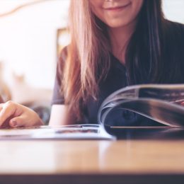 woman reading a magazine in a cafe