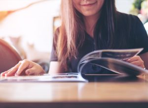 woman reading a magazine in a cafe