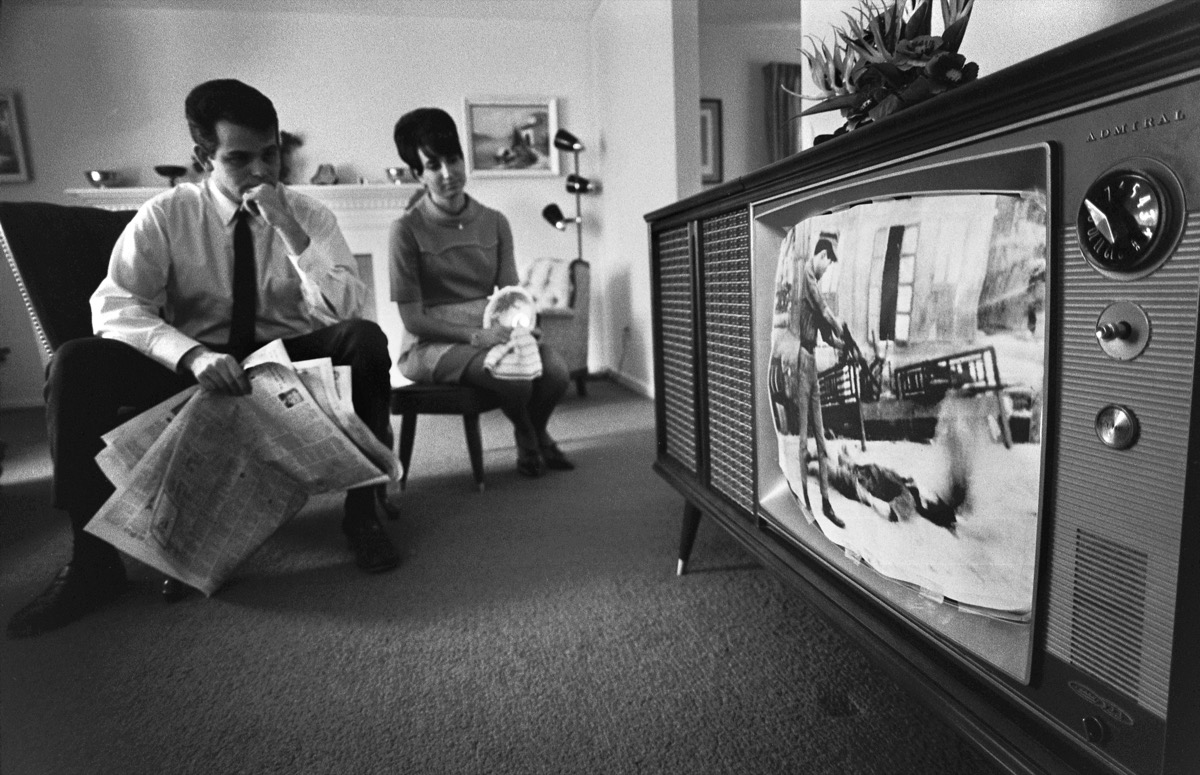 1960s Man and Woman Watch TV In Living, Sitting On Chairs, He Has a Newspaper, Life Before Technology royal wedding facts