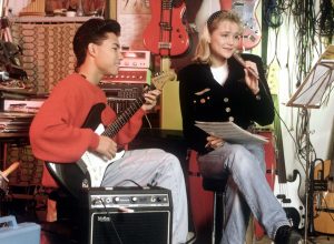 teenage couple playing a song together in the 1980s