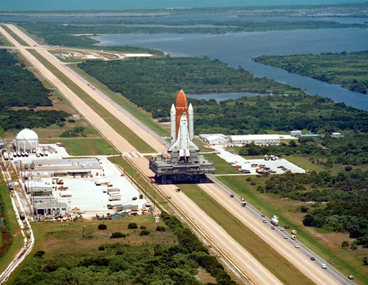 Space Shuttle Challenger is carried by a Crawler-transporter on the way to its launch pad, prior to its final flight before being destroyed in the Space Shuttle Challenger disaster.