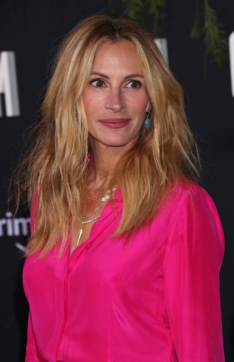 Timeless hairstyle on Julia Roberts, messy shag while wearing bright pink top