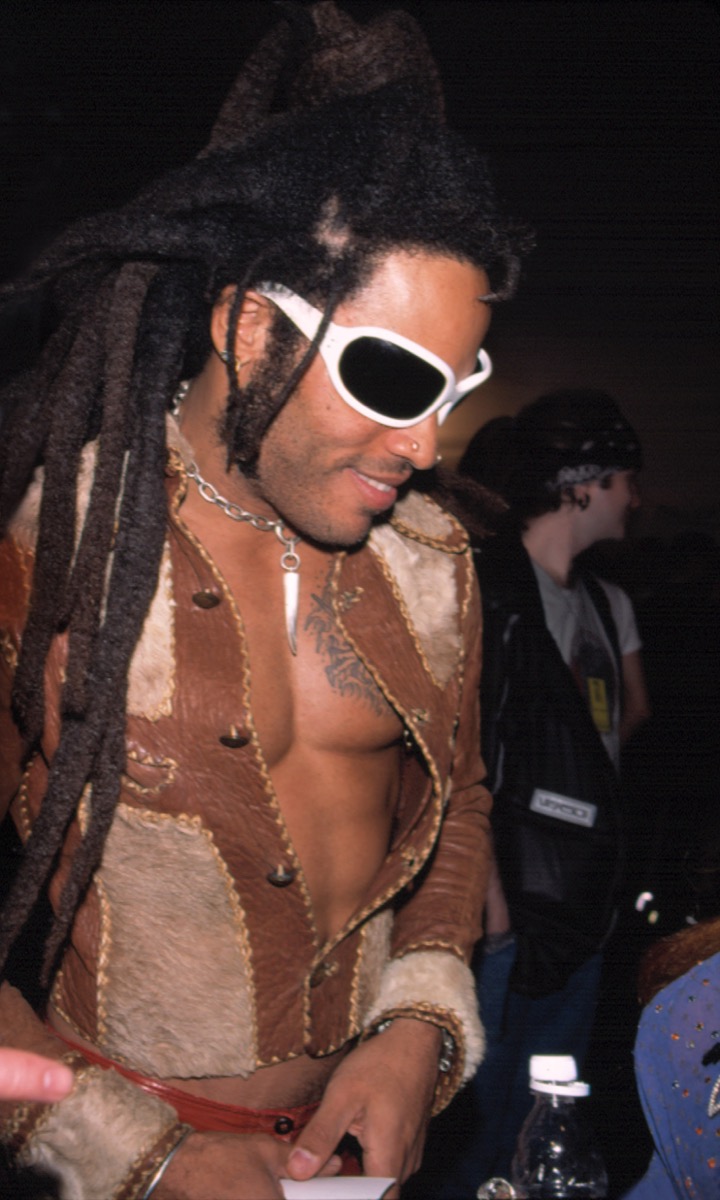 Celebrity Lenny Kravitz in cowboy jacket and white sunglasses at 1998 Betsey Johnson Fashion Show