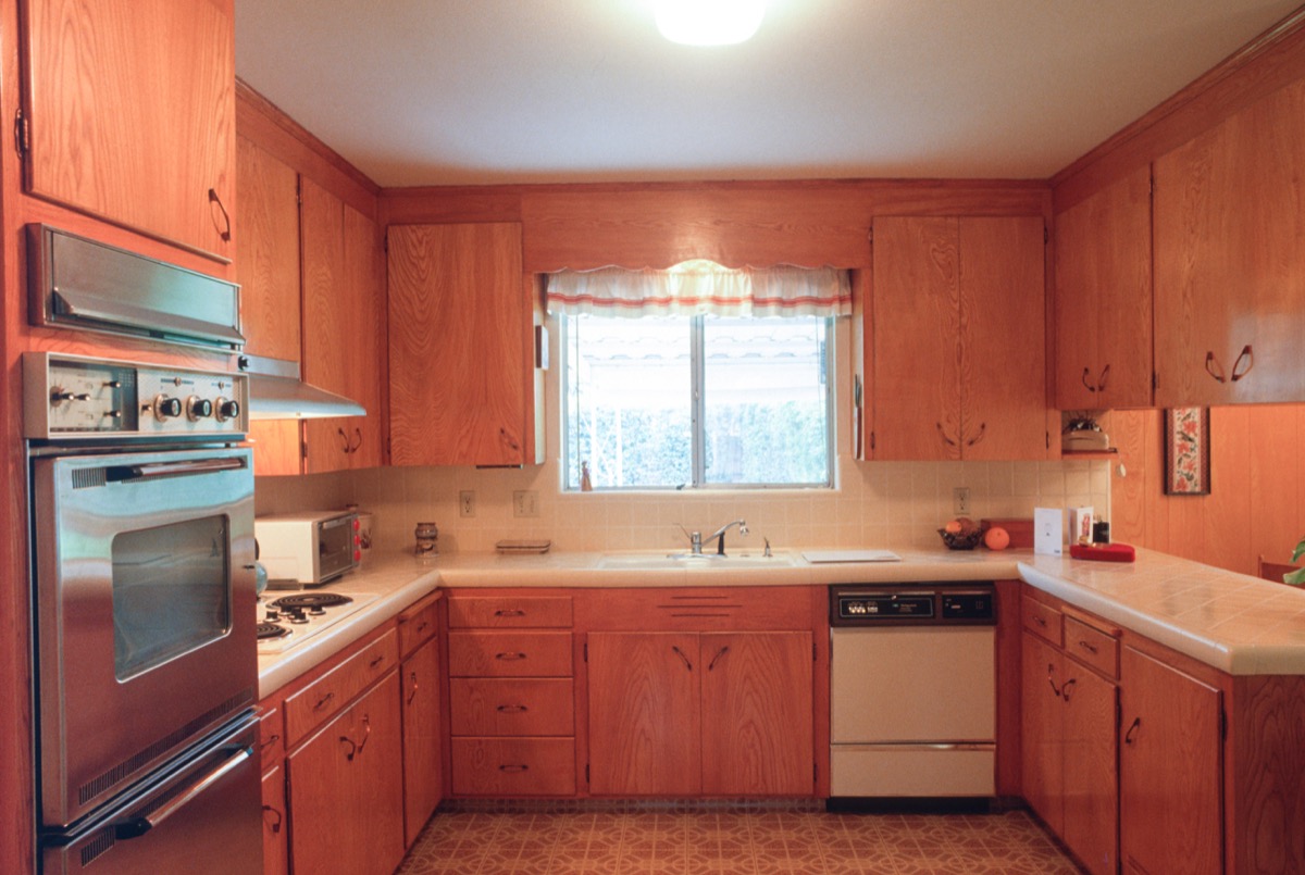1960s kitchen handmade wooden cabinets, dishwasher, and gas range