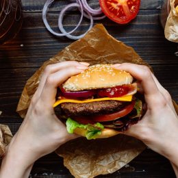 Person holding a burger