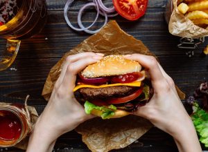 Person holding a burger