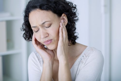 Woman experiencing ear pain
