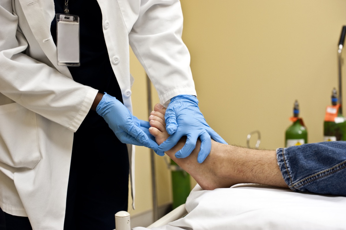 doctor examining patient's toes