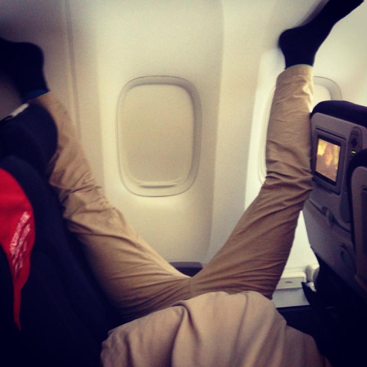 Man manspreading on plane photos of terrible airplane passengers