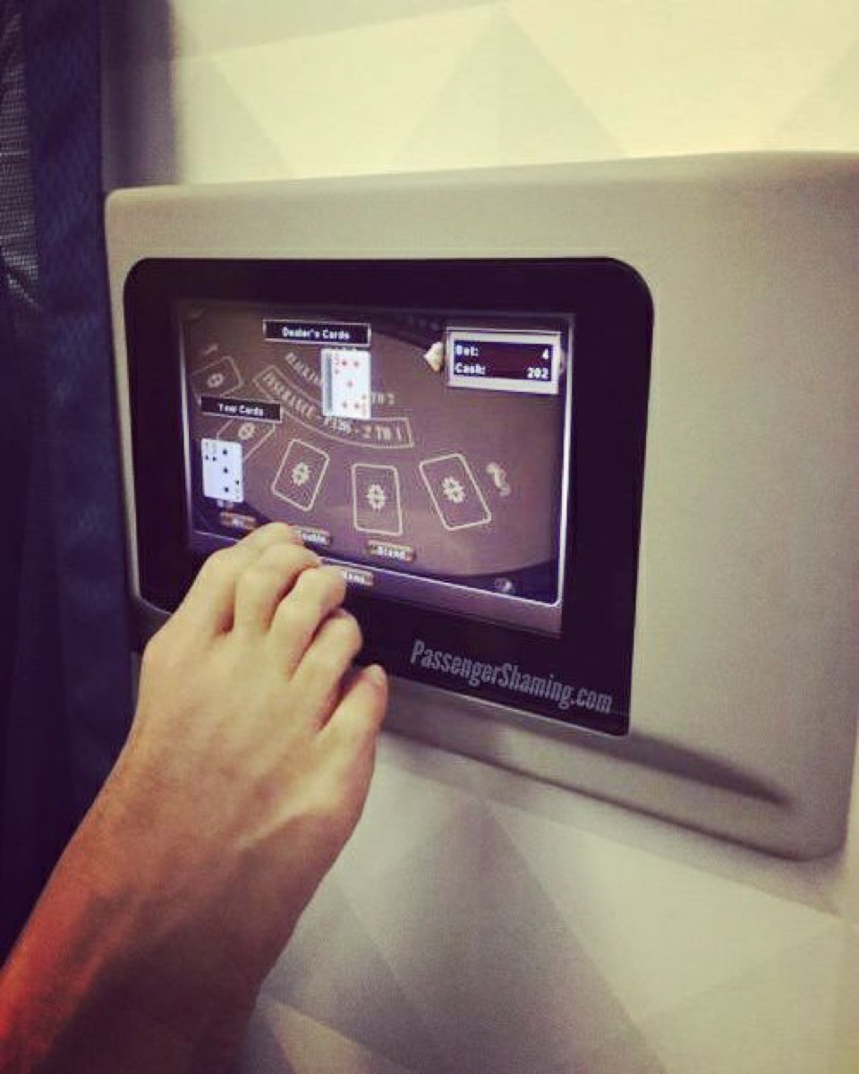 Man playing game with foot on airplane photos of terrible airplane passengers