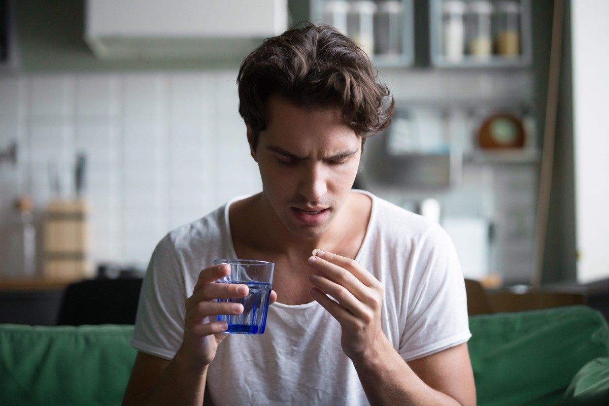 Man taking antidepressants mixing alcohol