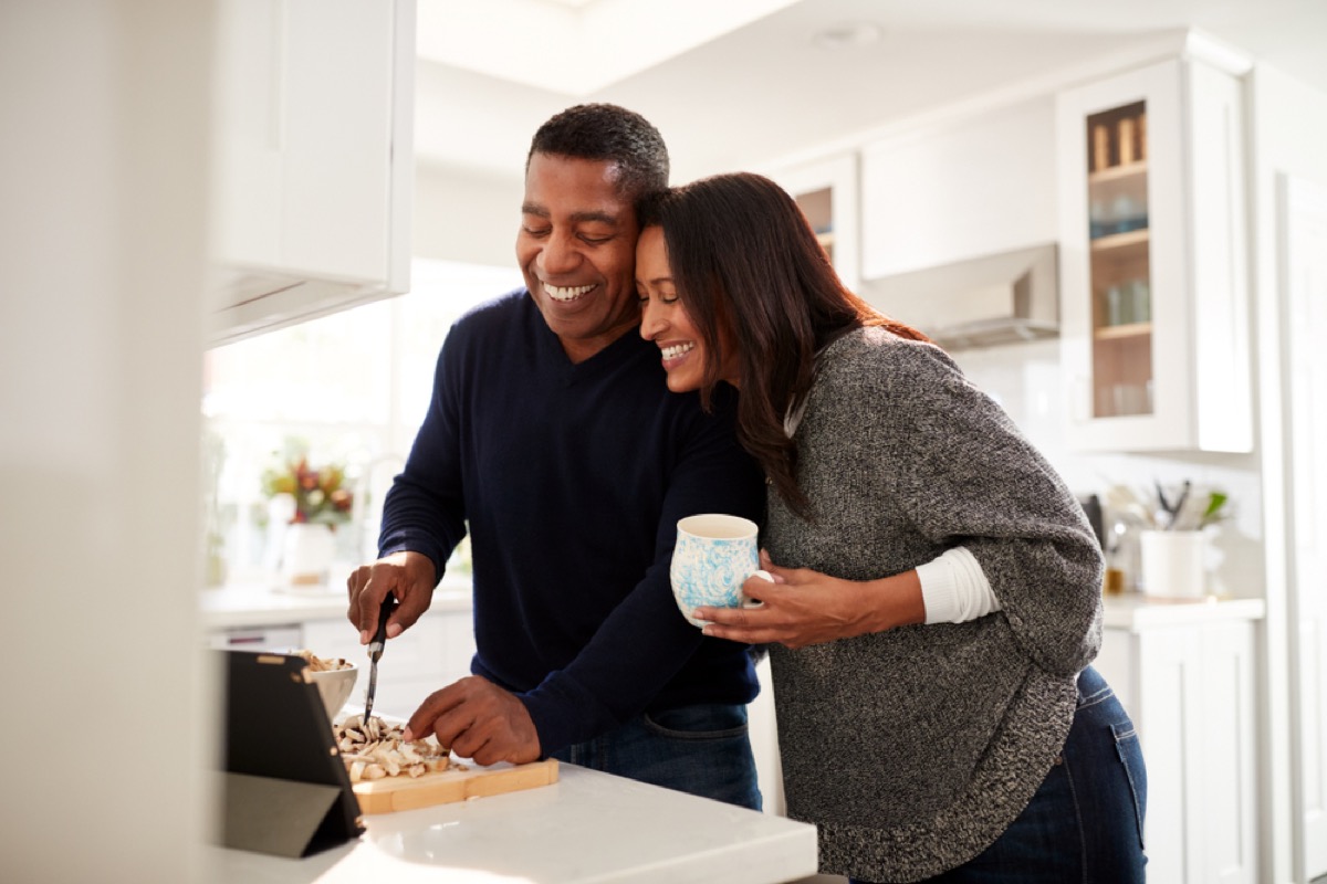 middle aged black couple cooking over stove, health changes over 40