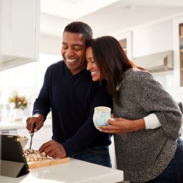 middle aged black couple cooking over stove, health changes over 40