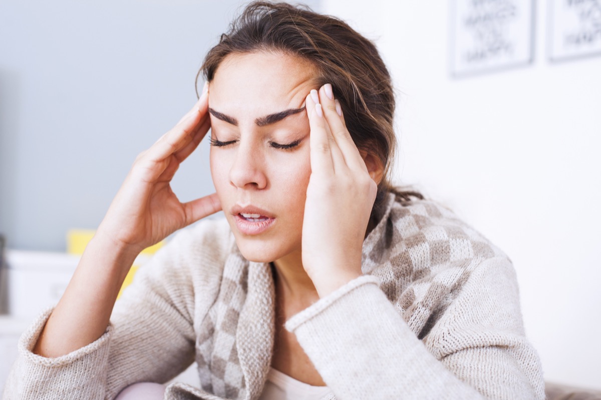 Woman waking up with headache