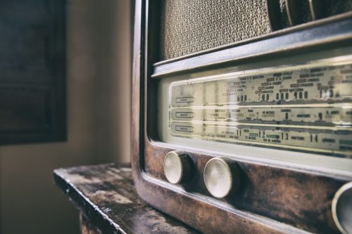 Obsolete radio in wooden case. Horizontal indoors shot - Image